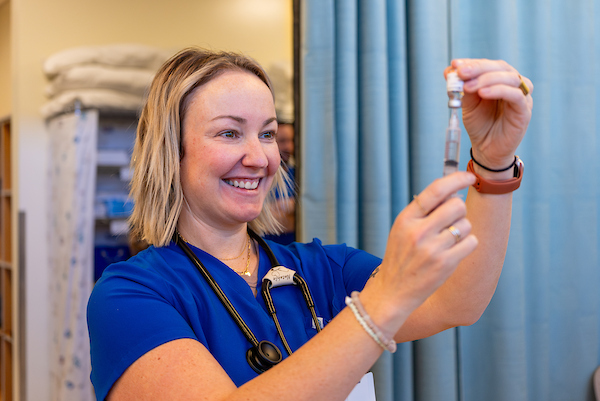 COCC nursing student preparing a syringe in a lab