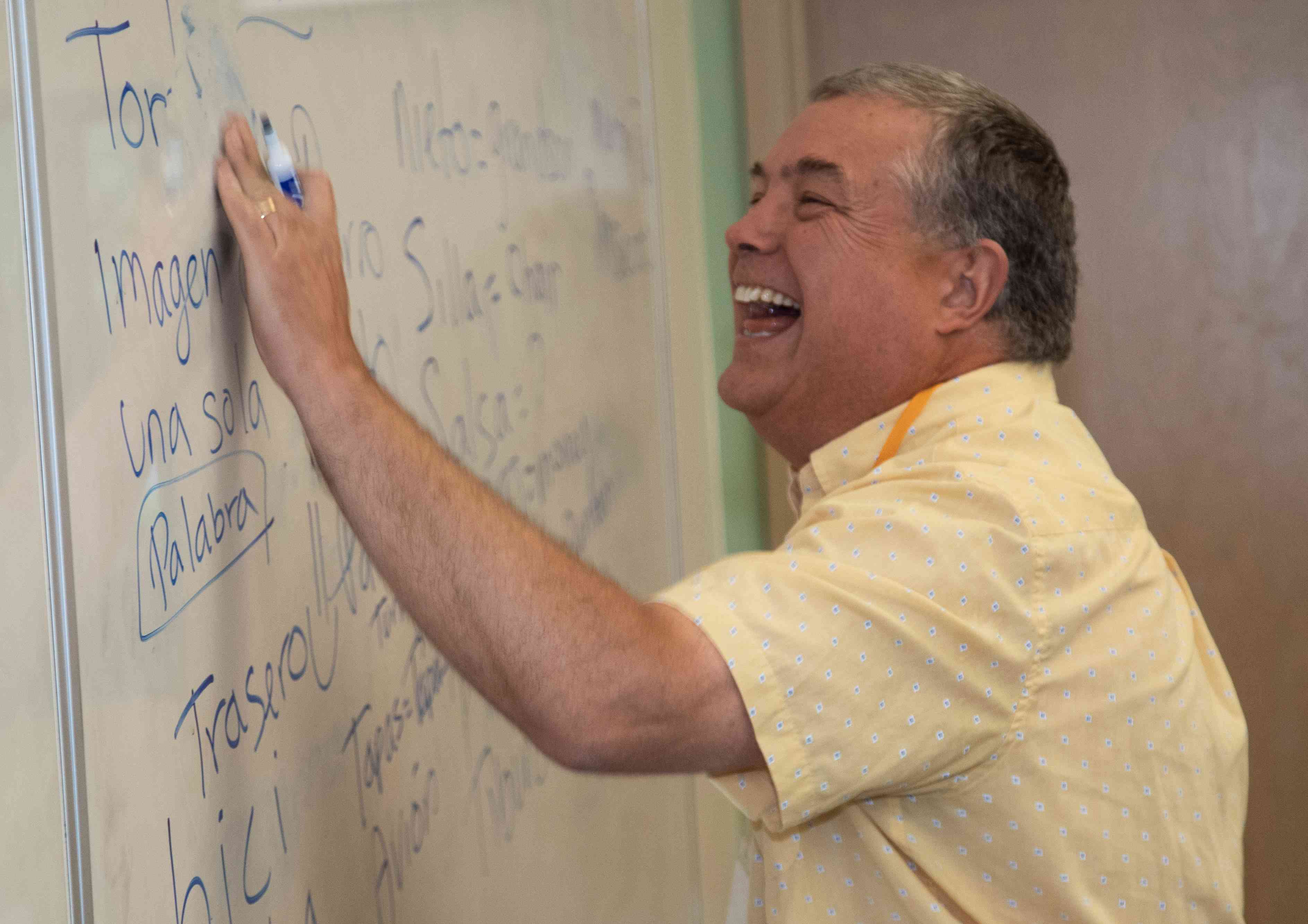 Instructor smiling at whiteboard