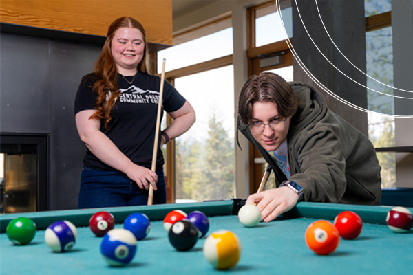 Student playing billiards, one of the amenities offered at Wickiup Hall