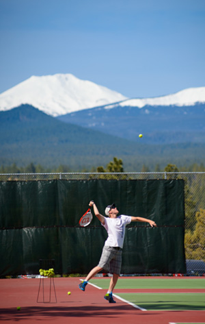 Tennis playing preparing to serve a tennis ball